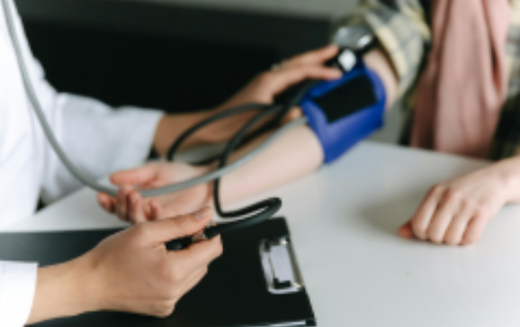 A Doctor testing a patient for blood pressure